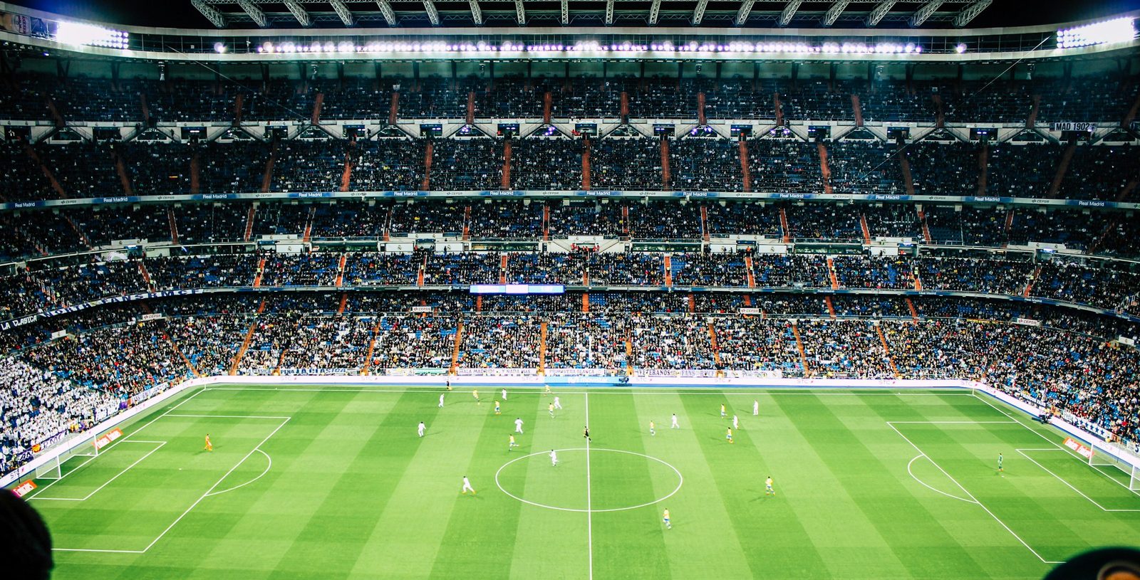 A packed football stadium under floodlights, streamed live on DrogonTV